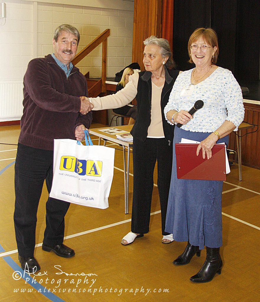 man shaking hands with two women 